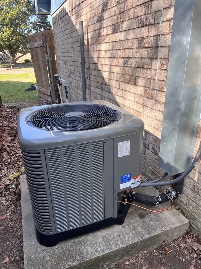 Brand new outdoor condenser unit installed at a Houston home